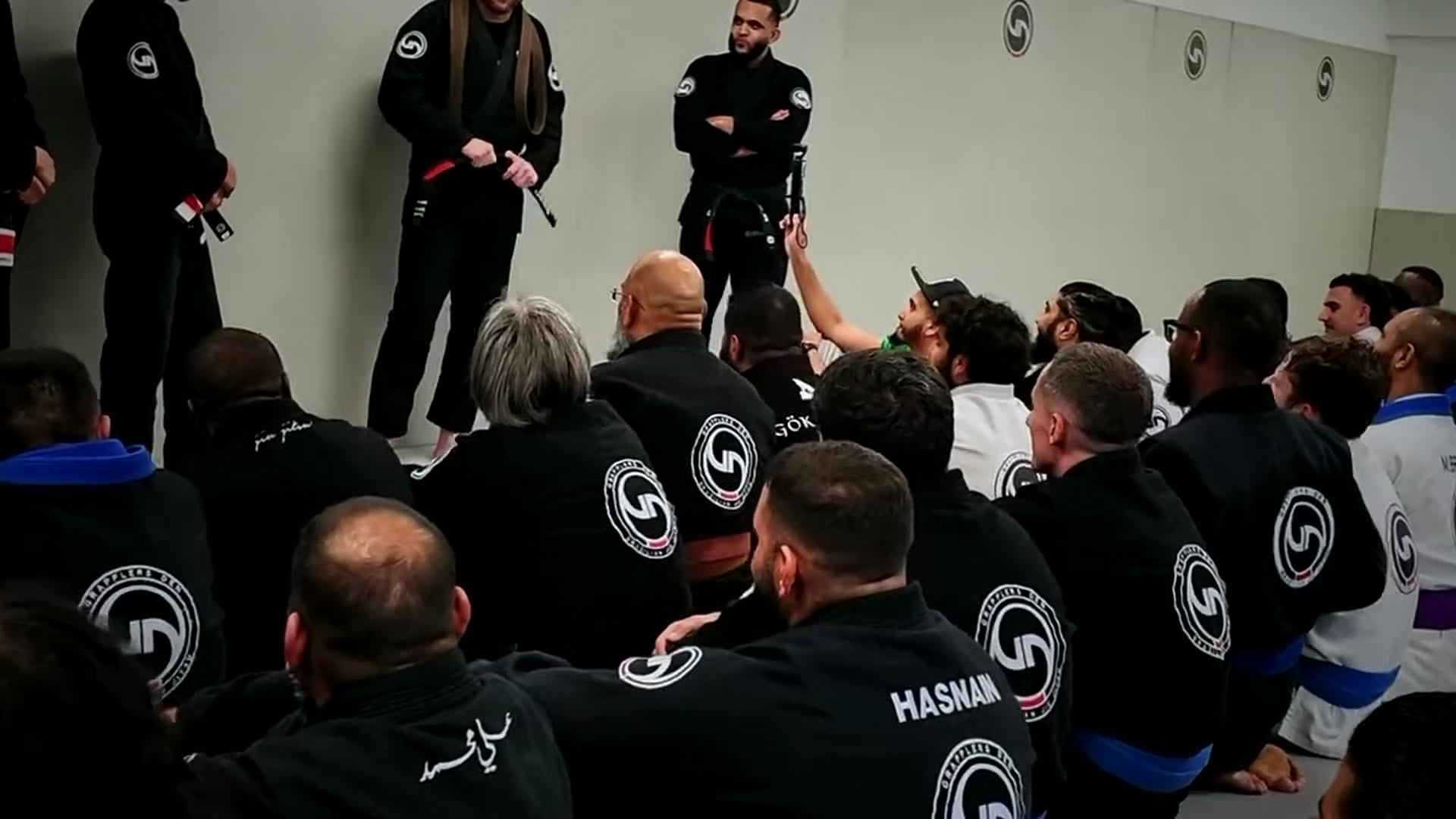 Grapplers Den members training on the mats